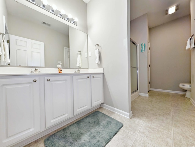 bathroom with tile patterned flooring, walk in shower, and vanity