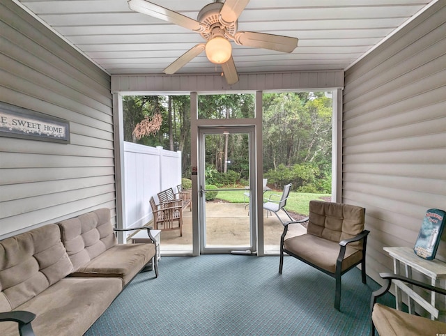 sunroom / solarium featuring ceiling fan