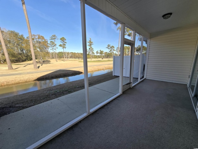 unfurnished sunroom with a water view