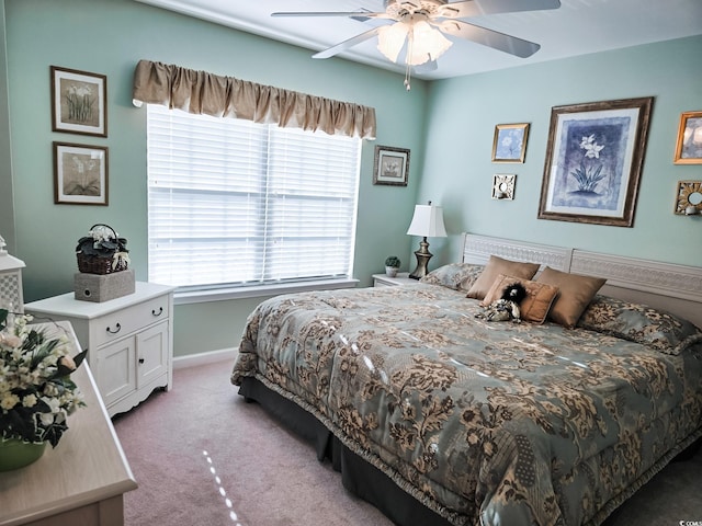 bedroom featuring ceiling fan, light colored carpet, and multiple windows