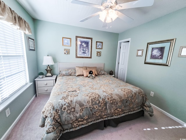 bedroom featuring ceiling fan, a closet, and carpet