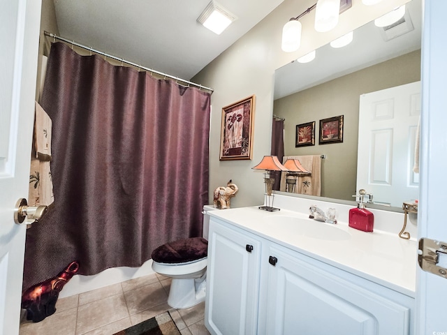 bathroom featuring tile patterned flooring, vaulted ceiling, vanity, and toilet