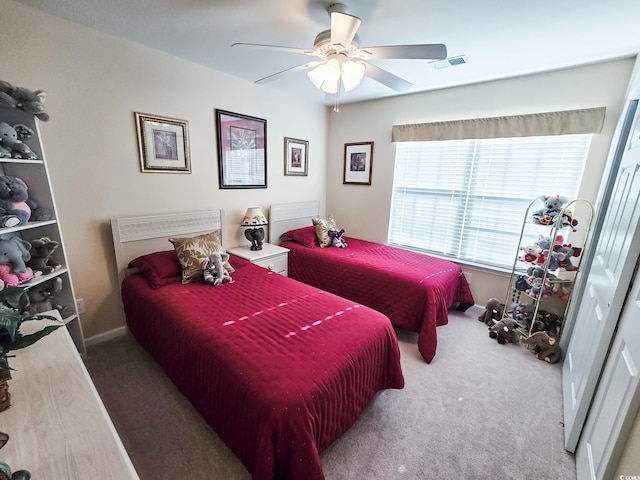 carpeted bedroom featuring a closet and ceiling fan