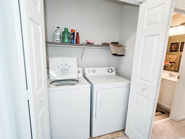 clothes washing area with sink and washing machine and dryer