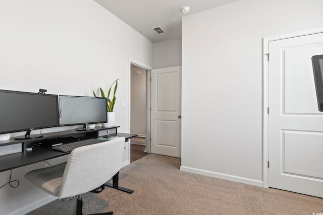 office area featuring light carpet