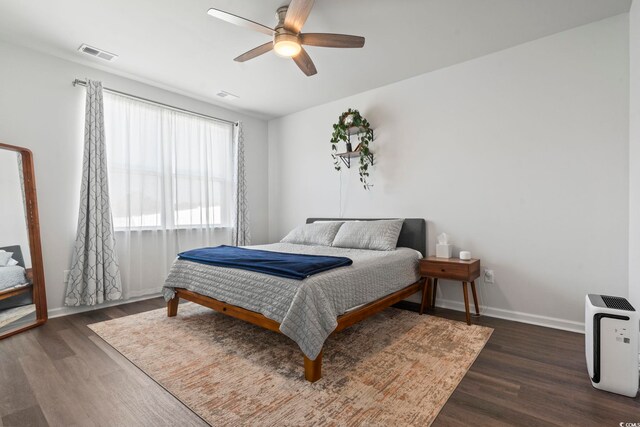 bedroom with ceiling fan and dark hardwood / wood-style flooring