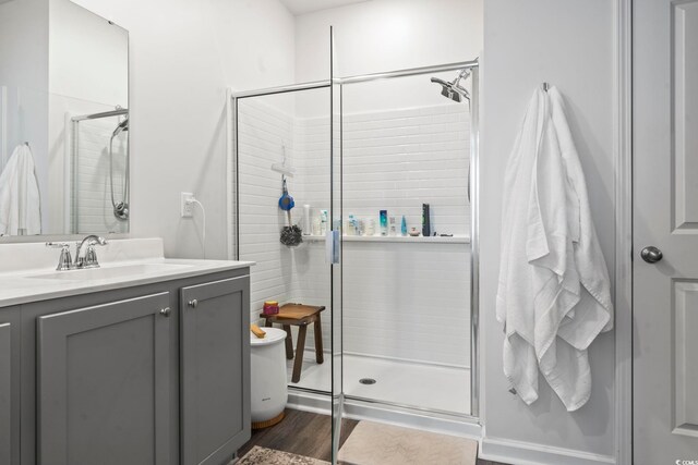 bathroom featuring vanity, hardwood / wood-style floors, and an enclosed shower