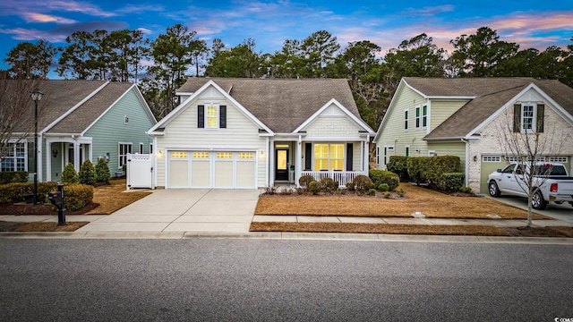 view of front of property featuring a garage and covered porch