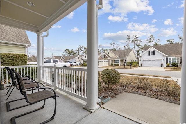 view of patio featuring a porch and a garage