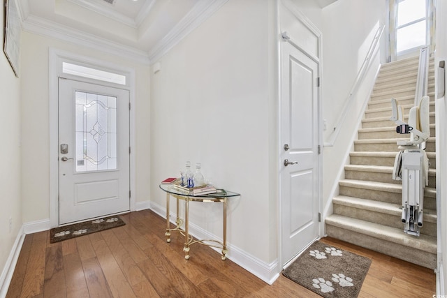 entryway featuring hardwood / wood-style floors and crown molding