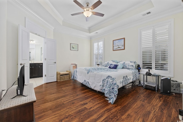 bedroom featuring dark hardwood / wood-style floors, a raised ceiling, and ceiling fan