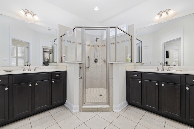 bathroom featuring tile patterned floors, a shower with door, and vanity