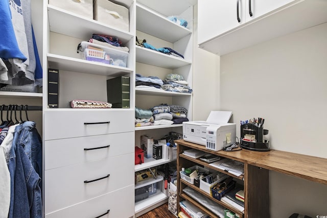 walk in closet with dark wood-type flooring