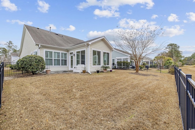 back of house with a yard