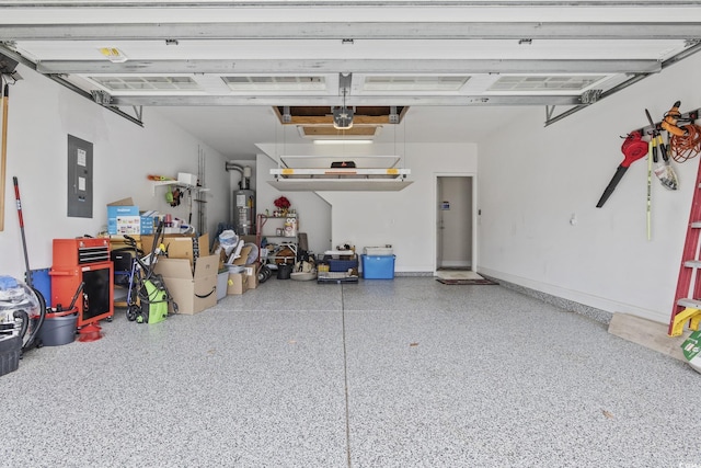 garage with a garage door opener, electric panel, and water heater