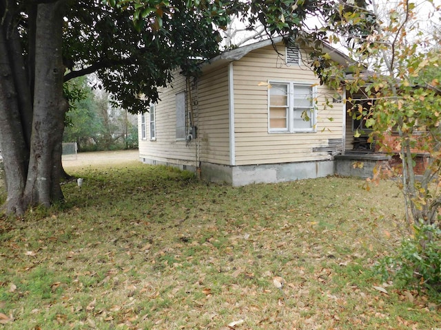 view of side of property with a yard