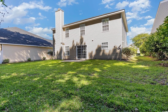 rear view of house with a patio area and a lawn