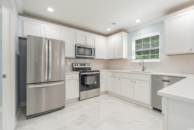 kitchen featuring sink, crown molding, appliances with stainless steel finishes, tasteful backsplash, and white cabinets