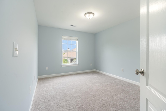 unfurnished room featuring light carpet