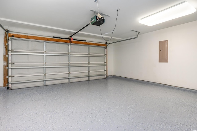 garage with a garage door opener and electric panel