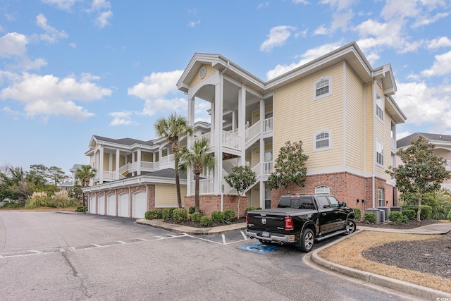 view of building exterior with community garages