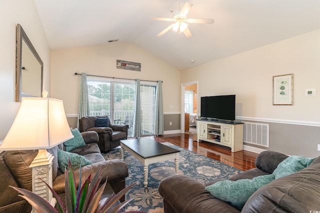 living area with dark wood-style floors, visible vents, vaulted ceiling, and a ceiling fan