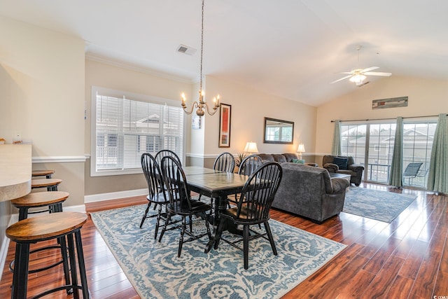 dining room with baseboards, visible vents, dark wood finished floors, vaulted ceiling, and ceiling fan with notable chandelier