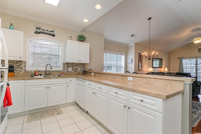 kitchen with a peninsula, a sink, white cabinets, open floor plan, and dishwasher