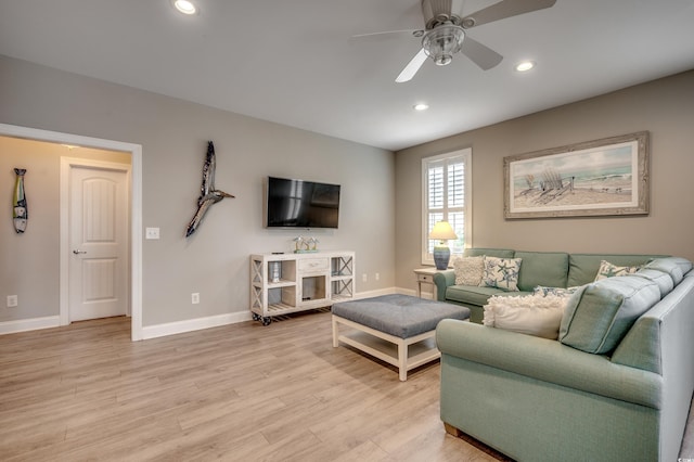 living room featuring ceiling fan and light wood-type flooring