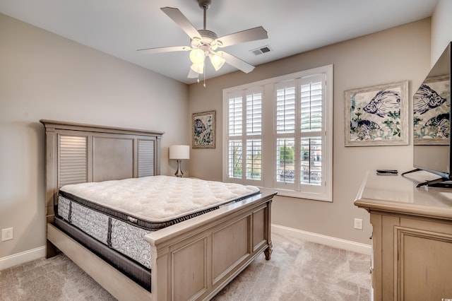 bedroom with ceiling fan and light colored carpet