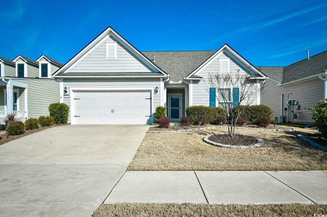 view of front of home featuring a garage and central AC