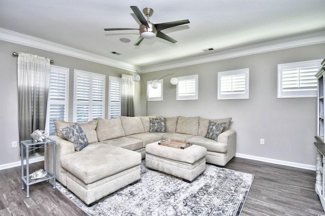 living room with crown molding, a healthy amount of sunlight, and dark hardwood / wood-style flooring