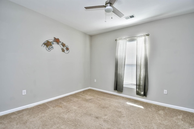 unfurnished room featuring ceiling fan and light carpet