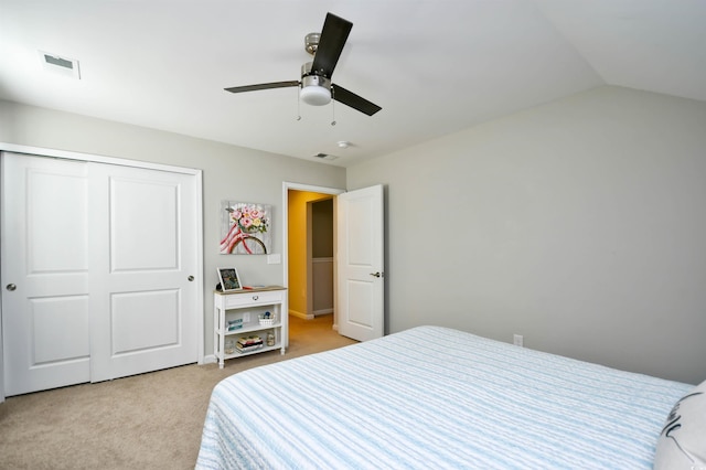 carpeted bedroom featuring vaulted ceiling, ceiling fan, and a closet