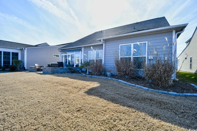 back of property featuring a lawn