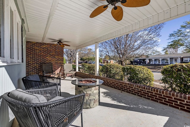 view of patio featuring an outdoor fire pit and ceiling fan