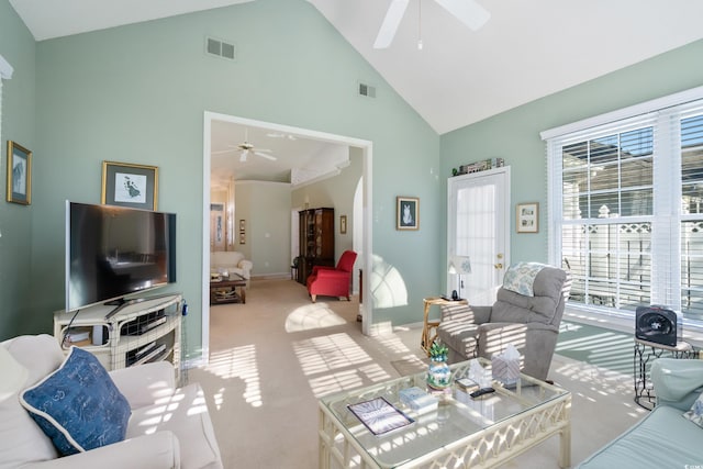 living room with light carpet, ceiling fan, and high vaulted ceiling