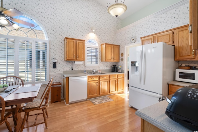 kitchen featuring a wealth of natural light, sink, and white appliances