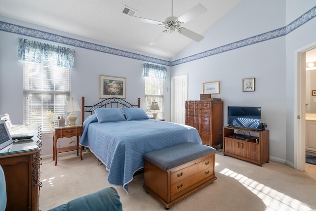 carpeted bedroom with ceiling fan, connected bathroom, and lofted ceiling