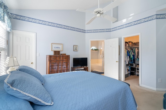 carpeted bedroom with ceiling fan, connected bathroom, a closet, vaulted ceiling, and a walk in closet