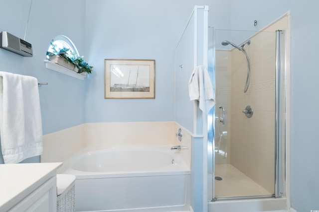 bathroom featuring vanity and independent shower and bath