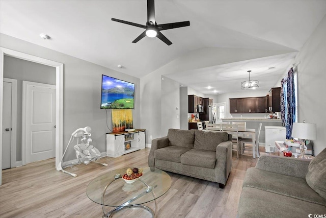 living room with ceiling fan, light hardwood / wood-style flooring, and lofted ceiling