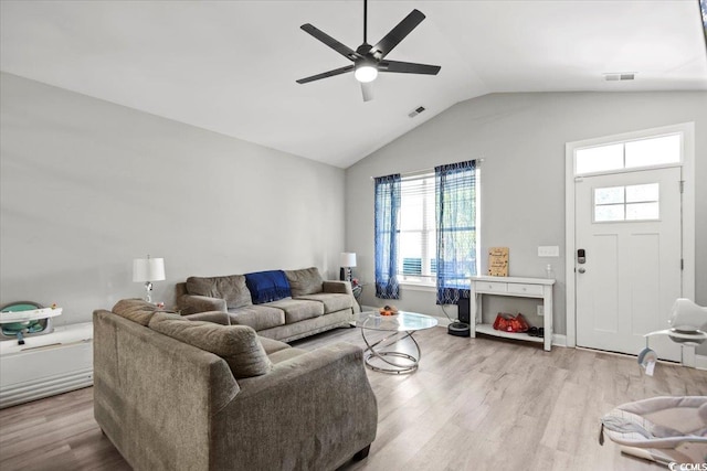 living room featuring ceiling fan, lofted ceiling, and light hardwood / wood-style floors