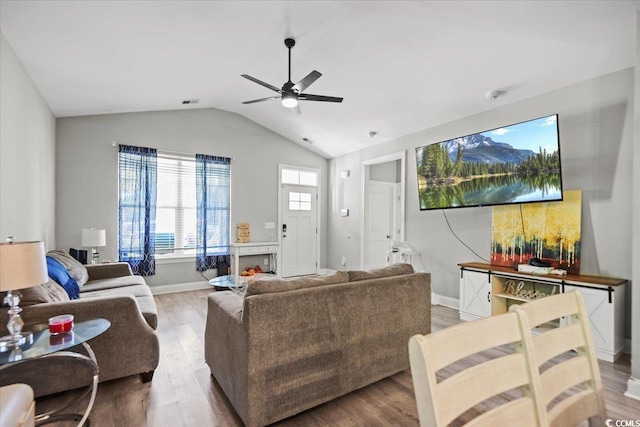 living room featuring ceiling fan, wood-type flooring, and lofted ceiling