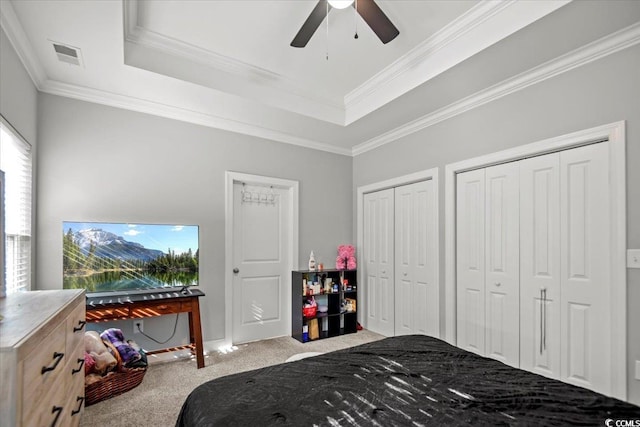 bedroom featuring ceiling fan, ornamental molding, light colored carpet, and a raised ceiling