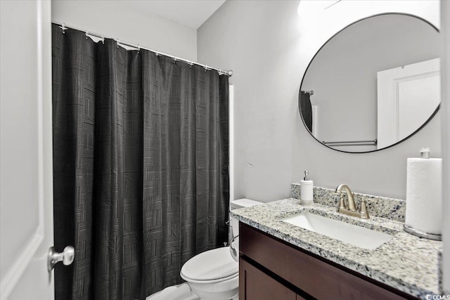 bathroom with toilet and vanity