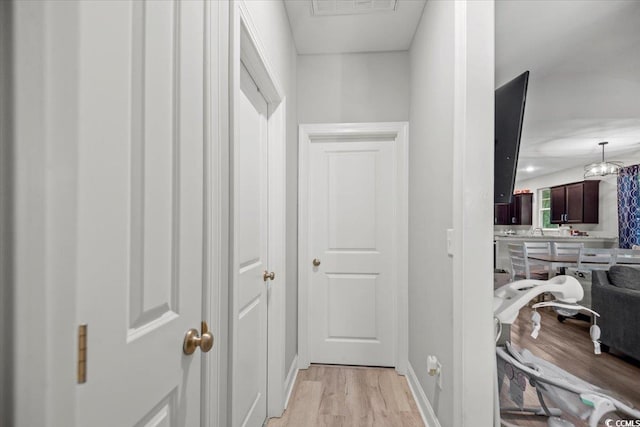 hallway with light wood-type flooring