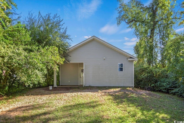 rear view of house with a yard