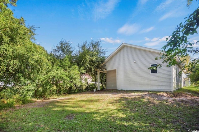 view of home's exterior with a lawn