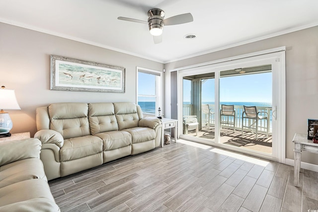 living room with ceiling fan, ornamental molding, and a water view